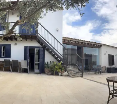 a patio with a staircase leading up to a house at The Family Nest - Traditional Serenity in Nicosia