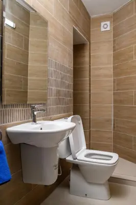 a bathroom with a toilet and a sink at Ollies 3 Bedroom Apartment in Larnaka