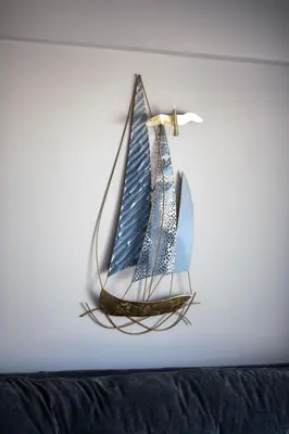a model boat hanging on a wall at Ollies 3 Bedroom Apartment in Larnaka