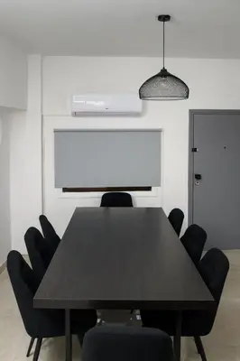 a conference room with a black table and chairs at Ollies 3 Bedroom Apartment in Larnaka