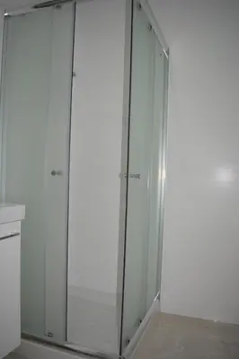 a white closet with glass doors in a room at P.L Hermes Studios & Apartments in Larnaka