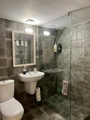 a bathroom with a toilet and a sink and a shower at FatCow Beach House 43 in Larnaka