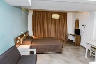 a hotel room with a bed and a couch at Sweet Memories Hotel Apts in Protaras