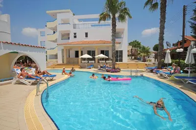 a group of people in a swimming pool at a resort at Petrosana Hotel Apartments in Ayia Napa
