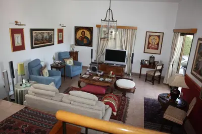 a living room with a couch and a tv at Residence L' Aubrais in Limassol