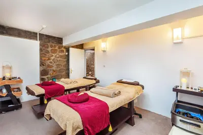a room with three beds with red blankets at Troodos Hotel & Spa in Troodos