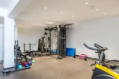 a gym with treadmills and machines in a room at Park Beach Hotel in Limassol