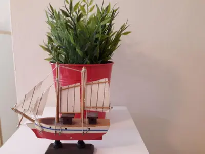 a planter with a plant in it on a table at Protaras Happy Sunny Holidays in Paralimni