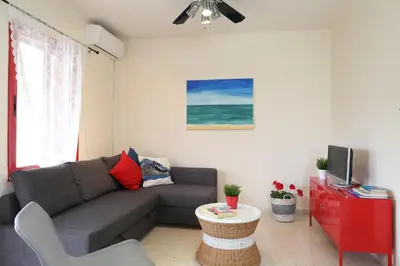 a living room with a couch and a tv at Protaras Happy Sunny Holidays in Paralimni