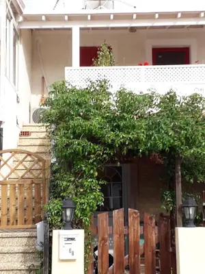 a tree in front of a house at Protaras Happy Sunny Holidays in Paralimni