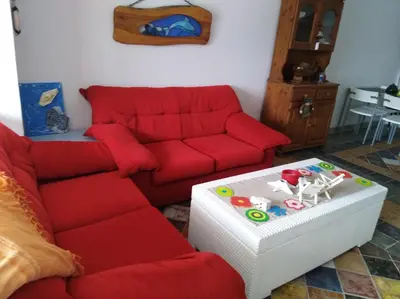 a living room with a red couch and a table at Il Mare in Larnaka