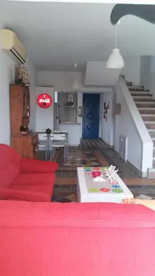 a living room with a red couch and a table at Il Mare in Larnaka