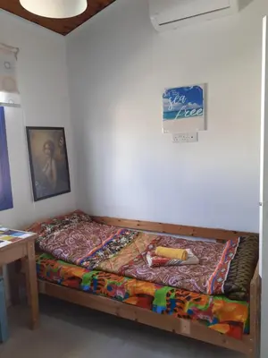 a bedroom with a bed with a colorful blanket on it at Il Mare in Larnaka