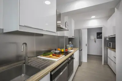 a kitchen with a counter with fruits and vegetables on it at Mackenzie Zoe Seafront Suite in Larnaka
