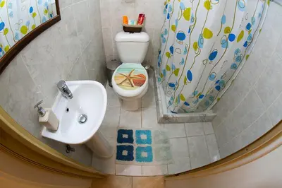 a bathroom with a sink and a toilet at Poseidon Boutique Apartment 1 in Limassol
