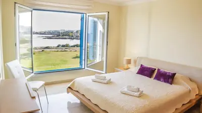 a bedroom with a bed and a large window at Luxury Bay View Villa 20 Right On Τhe Beach in Protaras