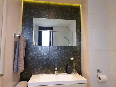 a bathroom with a sink and a mirror at Nicosia Cozy Nomad in Nicosia