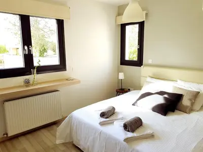 a bedroom with a white bed with towels on it at Nicosia Cozy Nomad in Nicosia