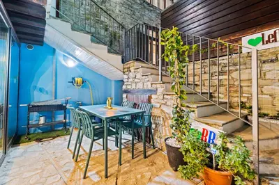 a table and chairs in a room with stairs at RedBlue Door Two Traditional Listed Houses in Pano Lefkara