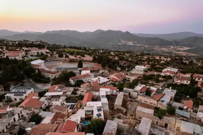 an aerial view of a town with mountains in the background at RedBlue Door Two Traditional Listed Houses in Pano Lefkara