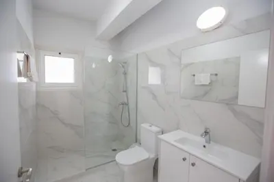 a bathroom with a shower and a toilet and a sink at Jason Villas in Protaras