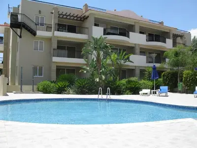a swimming pool in front of a apartment building at Pyla Gardens A102 in Pyla