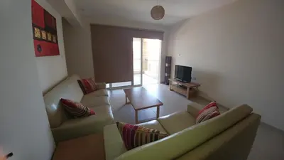 a living room with two couches and a television at Pyla Gardens A102 in Pyla