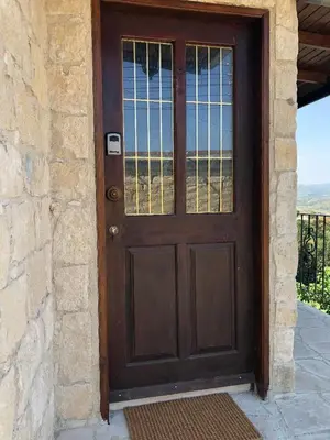 a wooden door with a view of the desert at Pachna Studios - Village Life in Limassol