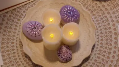 a plate with candles in the shape of a face at Mariliz in Larnaka