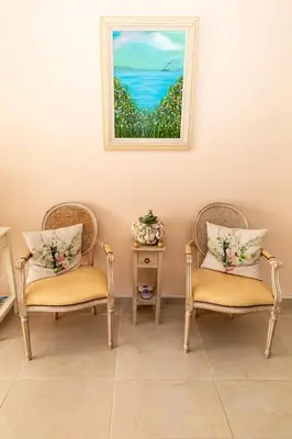two chairs in a room with a painting on the wall at Mariliz in Larnaka