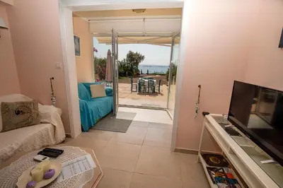 a living room with a couch and a television at Mariliz in Larnaka