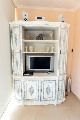 a blue and white cabinet with a tv in it at Mariliz in Larnaka