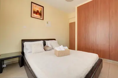 a bedroom with a bed with a basket on it at Nissi Villa Crystal in Ayia Napa