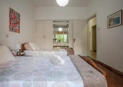 a hotel room with two beds and a window at Sunny Family Home By The Beach in Limassol