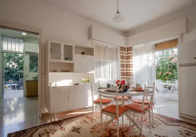 a kitchen with a table and chairs in a room at Sunny Family Home By The Beach in Limassol