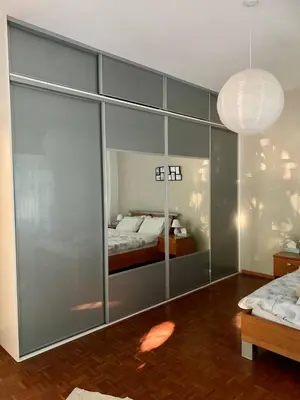 a bedroom with a bed and a large glass wall at Sunny Family Home By The Beach in Limassol