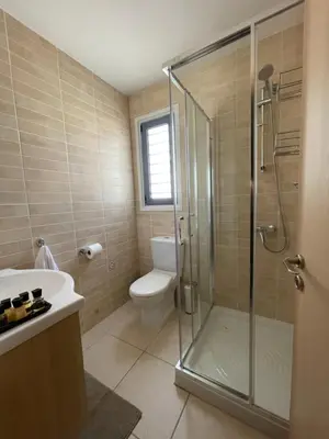 a bathroom with a shower and a toilet and a sink at Indigo in Protaras