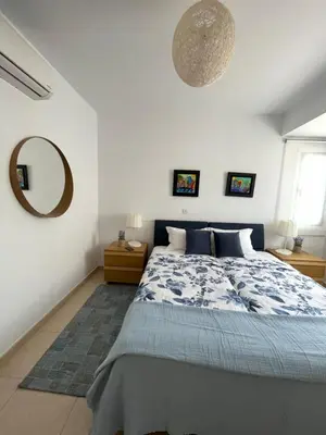 a bedroom with a bed and a mirror on the wall at Indigo in Protaras