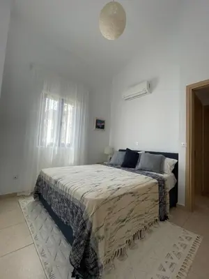 a white bedroom with a bed in a room at Indigo in Protaras