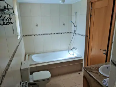 a bathroom with a tub and a toilet and a sink at ANTHORINA VILLA 9 in Protaras