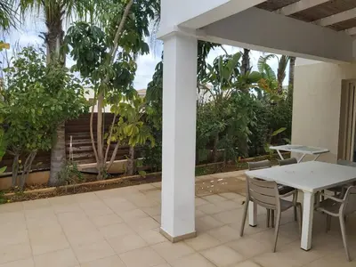 a patio with a white table and chairs at ANTHORINA VILLA 9 in Protaras