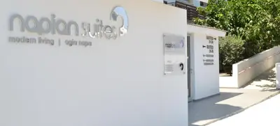 a vending machine next to a white building at Napian Suites in Ayia Napa