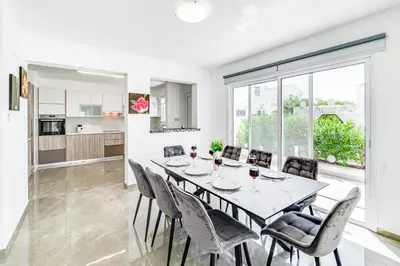 a kitchen and dining room with a table and chairs at Beach Front Aqua Marina by Ezoria Villas in Paralimni