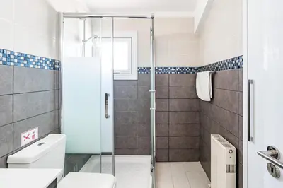 a bathroom with a shower and a toilet at Beach Front Aqua Marina by Ezoria Villas in Paralimni