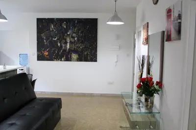 a living room with a couch and a glass table at Eclectic Business & Leisure in Nicosia
