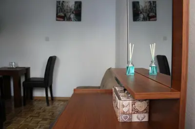 a living room with a table and a chair at Eclectic Business & Leisure in Nicosia