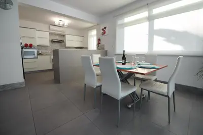 a kitchen and dining room with a table and chairs at Beach Front Bella Vista by Ezoria Villas in Protaras