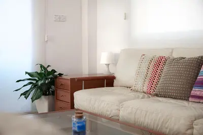a living room with a white couch and a table at Beach Front Bella Vista by Ezoria Villas in Protaras