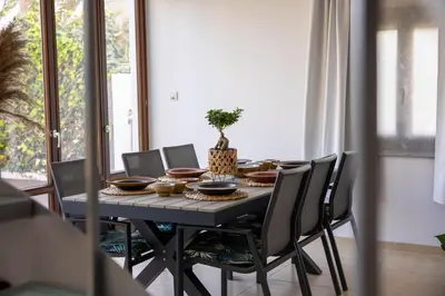 a dining room table and chairs with food on it at Balinese in Ayia Napa