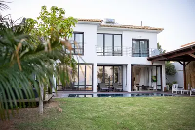 a house with a pool in front of it at Balinese in Ayia Napa